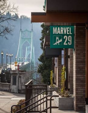 Portland apartment for rent - A green sign with white text that reads "MARVEL 29" is hanging on a building.